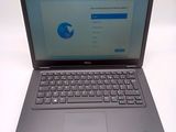 a dell laptop with a blue screen and a keyboard