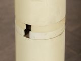 a white vase sitting on top of a wooden table