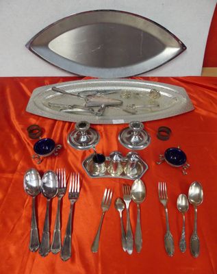a silver tray with silverware on a red table cloth