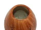 a wooden vase with a picture of animals painted on it