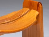 a wooden bench with a curved seat made of wood