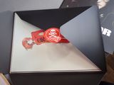 a black box with a red ribbon on top of it