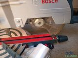 a machine that is sitting on the floor with a red handle