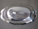 a silver platter on a table with a tag on it