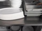 many plates and bowls on the counter in the kitchen