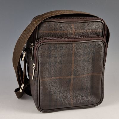 a close up of a brown cross body bag on a white background