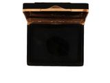 an image of a black and gold box with a black face on it