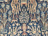 an antique persian rug with a floral design on a blue ground