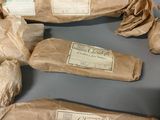 several pieces of paper are wrapped in brown paper and sitting on a table
