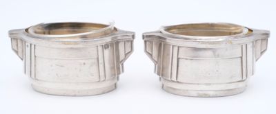 pair of silverplated sugar and creamers on a white background