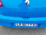 the rear end of a blue car with a sticker on it ' s bumper