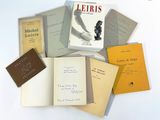 a pile of books sitting on top of a white table