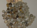 a pile of coins on the table next to a pile of money