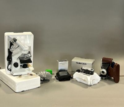 une boîte contenant un appareil photo, un étui pour appareil photo, un appareil photo et d'autres objets