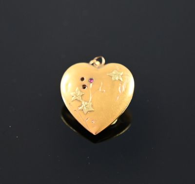 a close up of a gold heart with stars on it