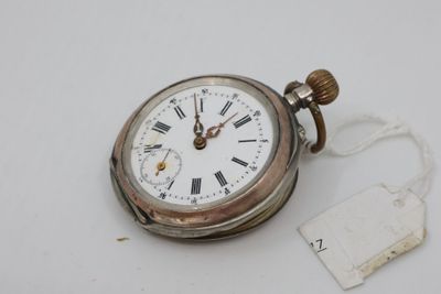a silver pocket watch with roman numerals on it