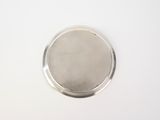 a small metal object on a white surface