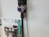 a vacuum that is sitting on the floor next to a wall