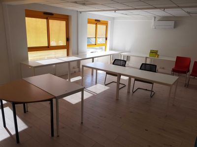 a room with tables and chairs in it and a window