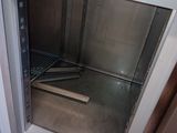 an open door to a stainless steel oven in a kitchen