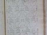 an open book with a drawing of a number of handprints on it