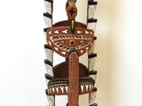 a wooden sculpture of a bird on top of a tree
