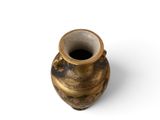 a small vase that is sitting on a white surface