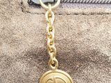 a close up of a purse with a keychain on it