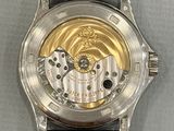 a close up of a watch with a gold dial