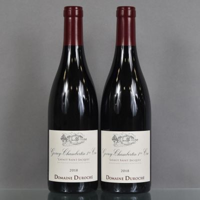 two bottles of wine sitting on a glass table
