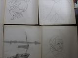 many drawings of people on a table in a room