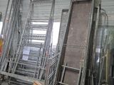 a room filled with lots of metal frames and ladders