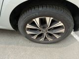 a close up of a tire on a car in a parking lot