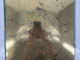 a picture of a person taking a picture of themselves in a mirror