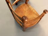 two wooden chairs sitting next to each other on a white surface