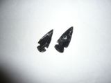 pair of black arrowheads on a white background