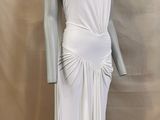 the mannequin is wearing a white dress on a mannequin stand
