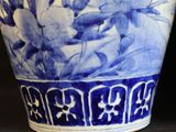 a blue and white vase sitting on a table