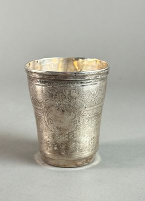 a silver cup that is sitting on a table