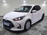 the white toyota yaris is parked on a checkered floor
