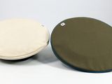 pair of two round cushions on a white surface