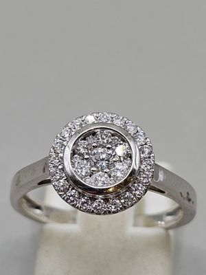 gros plan d'une bague en diamant sur une surface blanche