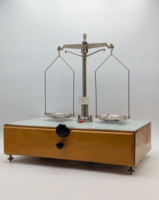 an image of a scale on a table with a bottle of wine