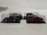 three toy cars that are sitting in a display case