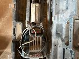 a metal box with wires in it on the floor