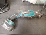 an image of a cordless drill is laying on a table