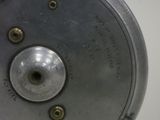 a close up of a metal object on a white surface
