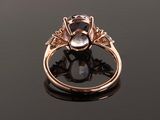 a close up of a gold ring with a white topaz and a blue topaz stone