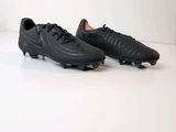 pair of black soccer cleats on a white surface