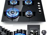 a black stove top with blue flames on it